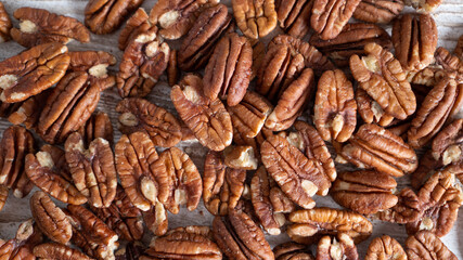 Peeled brown walnuts. Walnut background. Healthy harvest of nuts concept. Closeup of big shelled walnuts pile