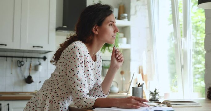 In home kitchen 35s woman read textbooks writes notes, create essay, make research, receive second higher education, enjoy self-education, prepares for seminar professional occupation training concept