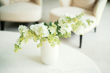 flowers are on the table in a glass, stylish cozy beautiful apartment