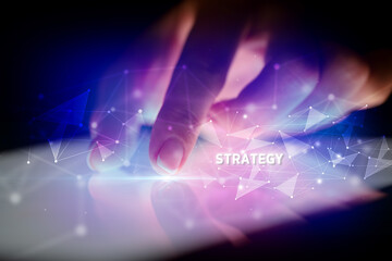 Finger touching tablet with STRATEGY inscription, business concept