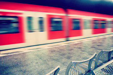 Munich underground train of the S-bahn line leaving the station platform - obrazy, fototapety, plakaty