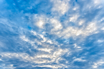 Naklejka na ściany i meble Sunlight ray on cloudy with blue sky background