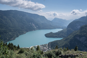 Fototapeta na wymiar Molveno Lake, located in Trentino, by Molveno village, surrounded by Brenta group in the west & Gazza & Pagenella mountains in the south & east, as seen from Pradel high plain, Dolomites, Italy