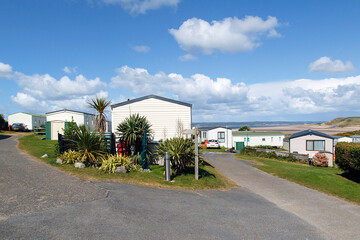Caravan Park - static caravans in Gower with a panoramic format and a blue sky background.