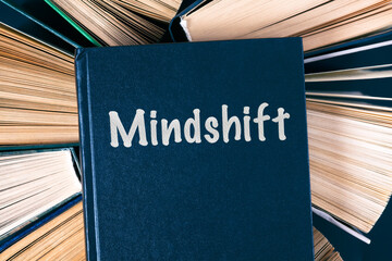 Old hardback books with book Mindshift on top.