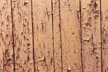 Natural abstract background of textured brown cracked wooden wall.