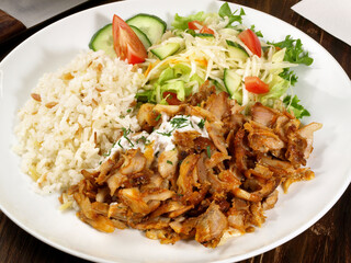 Gyros with Rice and Salad on wooden Background