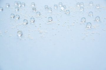 Abstract winter blue background, snow and small glass balls selective focus