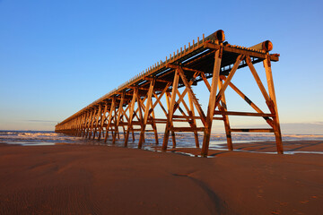 View of a wooden derelict Pier with Blue Sky at Hartlepool, County Durham, England, UK.