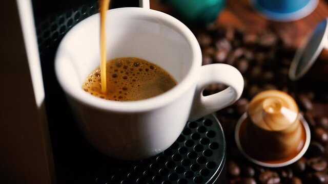 Automatic coffee machine with coffee capsules or coffee pods pouring espresso drink