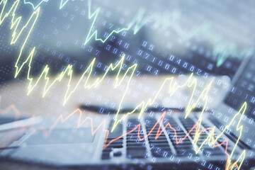 Forex market graph hologram and personal computer on background. Multi exposure. Concept of investment.