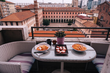 table with dishes on the balcony with beautiful city views. rest