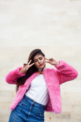 young cute girl teenager in pink fur coat gesturing hanging around outdoor , lifestyle people concept