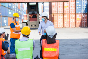 foreman is teaching and training workers how to wear face masks and take care of themselves while...