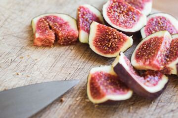 Pieces of fresh figs on a wooden board. Vegetables and fruits.