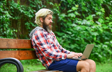 agile business. mature student working on computer. go shopping on cyber monday. bearded man on bench with laptop. online distant education. hipster inspired to work in park. preparing to the exams