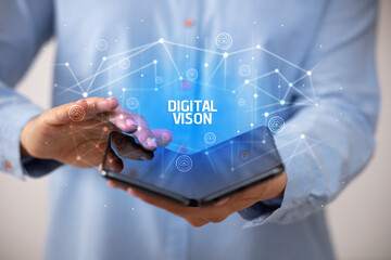 Businessman holding a foldable smartphone with DIGITAL VISON inscription, new technology concept