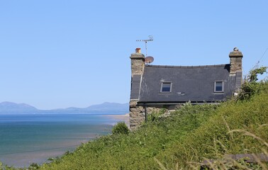 A quaint, old stone cottage with wonderful views, perched on the hillside above the coastline of Cardigan Bay in Wales.