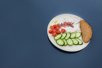 Sliced salted lard served with cucumber, tomato and bread. Traditional Russian snack. Homemade...