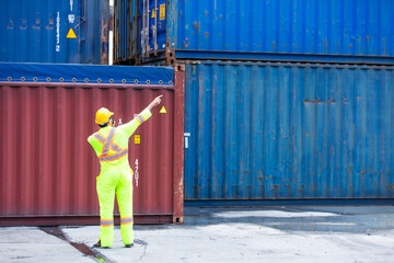 Container hispanic man worker talking on walkie-talkie to Colleague at container warehouse. Marine and carrier insurance concept