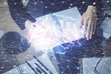Double exposure of writing hand on background with brain hologram. Concept of learning.