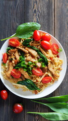 Pasta with fresh spinach cherry tomatoes and chunks of turkey.