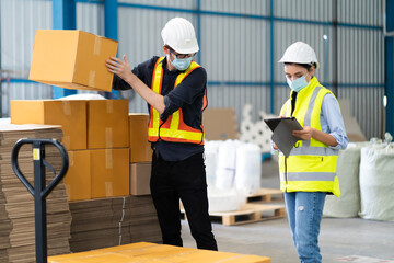 Female Inventory Manager checking stock on Digital Tablet. Man warehouse worker loading or...