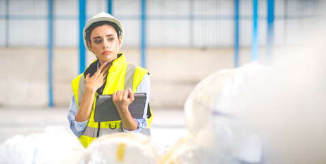 Female Inventory Manager working on digital tablet and checking quality of product at mask factory. Warehouse worker working at storage building.