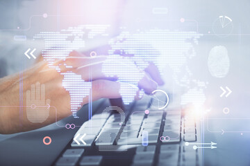 Double exposure of world map hologram with man working on computer on background. Concept of worldwideweb.