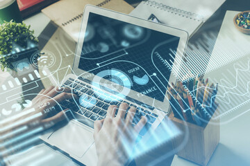 Technology theme hologram with man working on computer on background. High tech concept. Multi exposure.