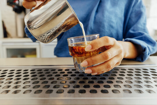 Close up of female barista making a flat white coffee 