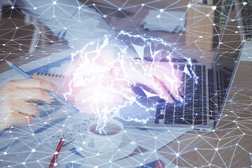 Businessman with computer background with brain theme hologram. Concept of brainstorm. Multi exposure.