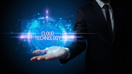 Man hand holding CLOUD TECHNOLOGY inscription, technology concept