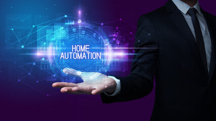 Man hand holding HOME AUTOMATION inscription, technology concept