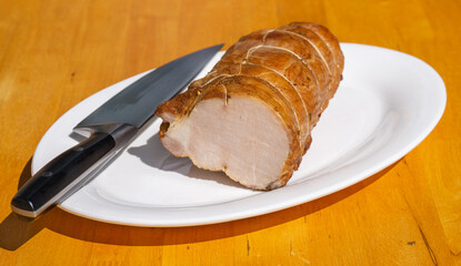 Smoked pork ham with rosemary. Cold cuts on a white plate