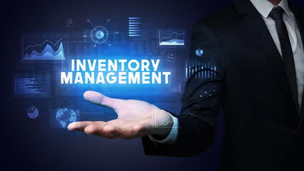 Hand of Businessman holding INVENTORY MANAGEMENT inscription, business success concept