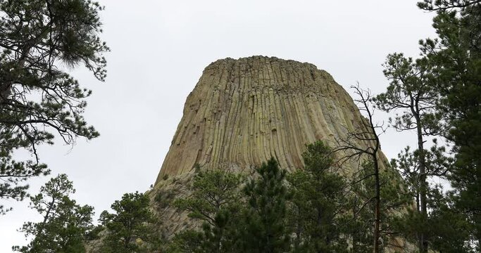 Devils Tower monument Wyoming rock climbers 4K. Rock tower in Black Hills Wyoming. United States National Monument. Recreation, tourism, vacation, and rock climbing destination.
