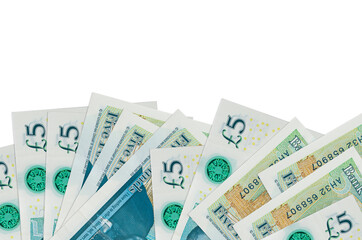 5 British pounds bills lies on bottom side of screen isolated on white background with copy space....