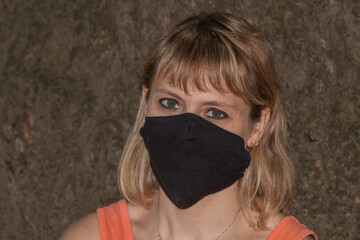 set portrait of a youg woman with blask protective mask © Mario