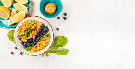 Ketogenic diet breakfast. Chicken salad with corn, lemon, mustard blueberries. Keto paleo lunch. Top view. Long banner format. space for text