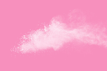 White powder explosion on pink background. Paint Holi.
