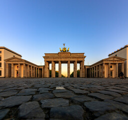 The German capital Berlin Brandenburg Gate House in sunrise with sun star