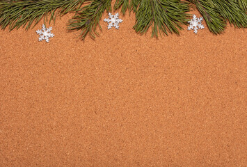 Empty corkwood notice board decorated with pine twigs and snowflakes. Christmas, new years...