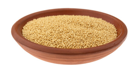 Side view of amaranth seeds in a small bowl isolated on a white background.