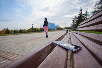 Lost smartphone on a bench in the city with copy space