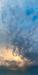 Fantastic clouds at sunrise, vertical panorama