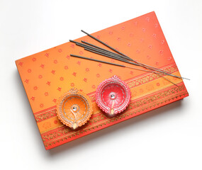 Isolated Diwali festive gift box with earthen lamps and sparklers. A box of sweet with sparklers...