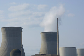 smoking cooling towers of nuclear power plant in front of cloudy sky