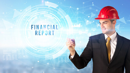 Handsome businessman with helmet drawing FINANCIAL REPORT inscription, contruction business concept