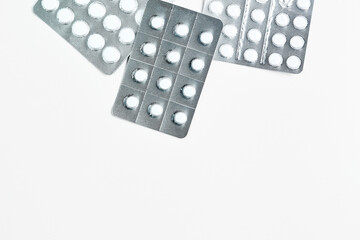 composition on a medical theme. silver blisters with pills on a white background. flat lay, copy space